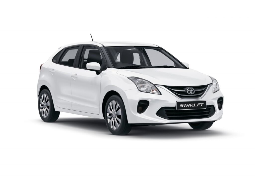 A white Toyota Starlet hatchback car is captured in a studio shot, standing against a clean white backdrop.