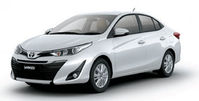 This is a white Toyota Yaris sedan parked in front of a white background.